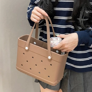 Close-up of khaki EVA beach tote featuring DIY perforated holes and small storage box
