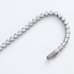 Dettaglio macro del bracciale tennis con zirconi a cuore e finitura lucida in acciaio 316L