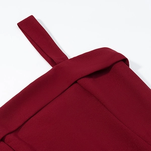 Detailed view of stitching and matte burgundy fabric on a backless halter dress