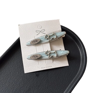 Set of two light blue and silver puppy hair clips on elegant display card