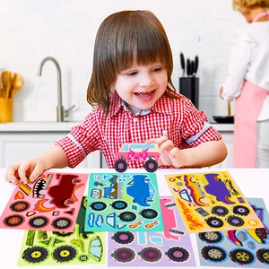 Close-up of a child DIY assembling cartoon monster truck stickers on a bright tabletop