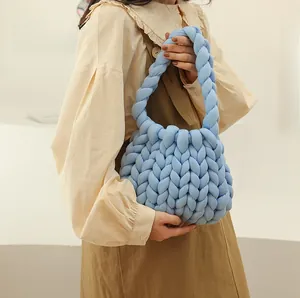 Detailed view of handmade blue chunky knit bag showing soft thick cotton yarn texture