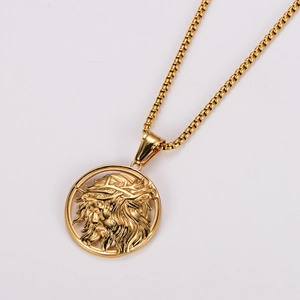 Macro shot of gold Jesus pendant with crown of thorns and box chain necklace