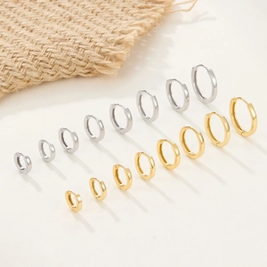 Macro detail of various sizes of S925 sterling silver hoop earrings in gold and silver