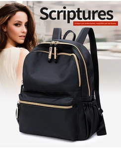 Modern black nylon backpack with gold zippers shown on a person in urban setting