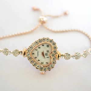 Elegant rose gold heart-shaped watch with diamond bezel and adjustable bolo bracelet