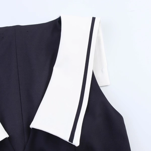 Detail of sailor style dress collar with navy blue fabric and white striped lapels