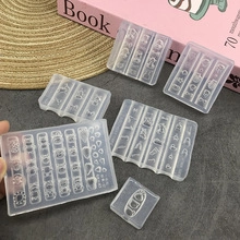 Close-up of six clear silicone nail art molds with vine floral patterns for DIY 3D decor
