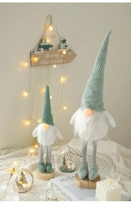 Detail of lit Christmas gnomes with corduroy hats and faux fur beards on a cozy background