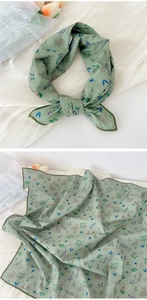 Detail of light green cotton linen scarf with rabbit and floral prints as a necktie