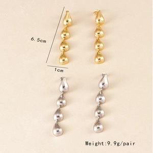 Detailed view of silver and gold teardrop tassel earrings showing 6.5cm length and weight