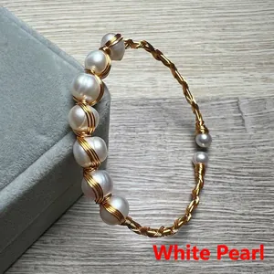 Detail of 14K gold-filled wire wrapped bangle with baroque white pearls and small beads