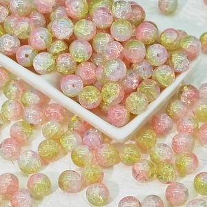 Macro detail of 10mm pink and green gradient glass beads for DIY jewelry making
