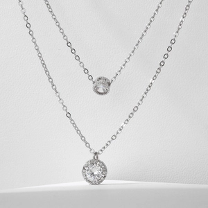 Double layer silver necklace with heart drop zircon pendant on white background