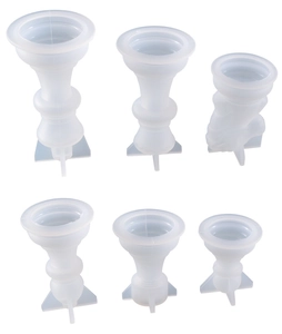 Close-up of six transparent silicone molds for resin chess pieces in various sizes and shapes