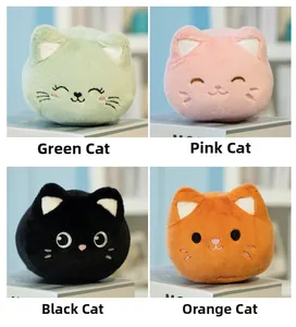 Detailed view of plush cat dolls in green, pink, black, and orange on a white book