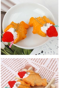 Detail of a fake Taiyaki pendant with cream and strawberry, hanging on a golden bead chain