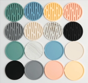 Overhead shot of multi-colored round silicone coasters in striped and flat styles