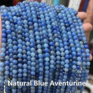 Close-up of natural blue aventurine round beads with unique mineral textures for jewelry DIY
