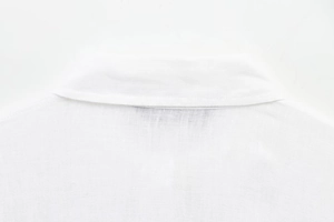 Close-up of the white shirt collar and back fabric showing detailed woven texture
