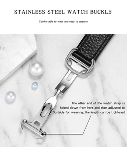 Polished silver stainless steel butterfly buckle on black leather watch strap detail