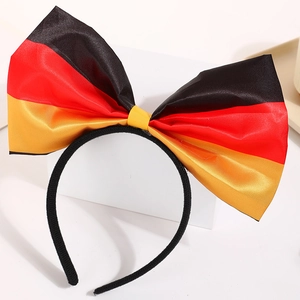 Detail showing a Germany flag satin bow headband with black, red, and yellow stripes