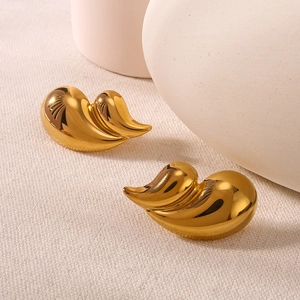 Polished 18K gold double layer water drop earrings on soft beige fabric background