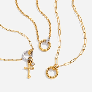 Detailed view of 18K gold plated stainless steel necklaces with mixed charms and link chains