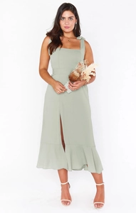 Elegant green ruffled midi dress featuring a square neckline and a front slit detail