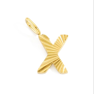 Detailed view of golden metal letter X pendant with sunburst texture and hanging loop