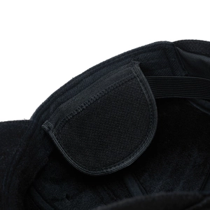 Detailed close-up of winter hat interior with adjustable velcro strap and elastic band
