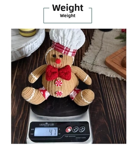 Detail showing gingerbread plush toy weight at 47g on a scale for shipping precision