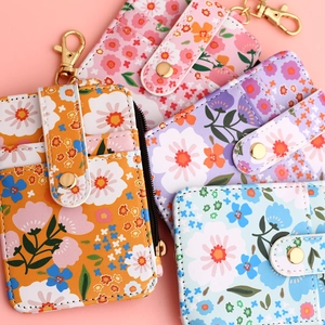Detailed view of floral PU leather card holders in various colors with gold hardware