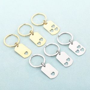 Polished stainless steel rectangular keychains with heart cutouts in gold and silver