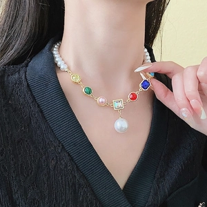 Colorful gemstone and pearl beaded necklace with a large round pearl pendant