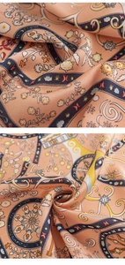 Macro shot of pink floral silk scarf fabric showing intricate patterns and glossy texture