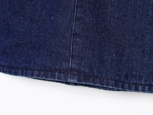 Gros plan détaillé du tissu denim bleu foncé avec double couture et texture sergé
