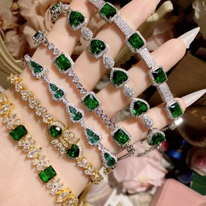 Vintage gold and silver bracelets with emerald green gemstones in various elegant cuts