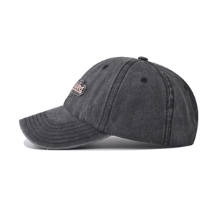 Detail of pink embroidered Styles script on washed charcoal cotton baseball cap