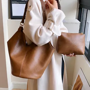 Elegant brown leather tote bag and matching clutch set for women with retro shoulder style