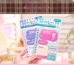 Close-up of DIY monthly planner stickers featuring dates and cute illustrative icons