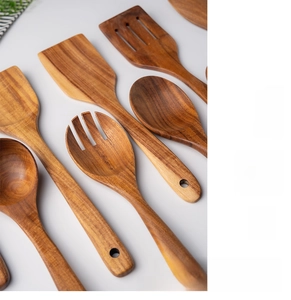 Detail of handcrafted whole wood teak kitchen utensil set with natural grain textures