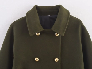 Detail of dark green wool coat collar with polished gold double-breasted buttons