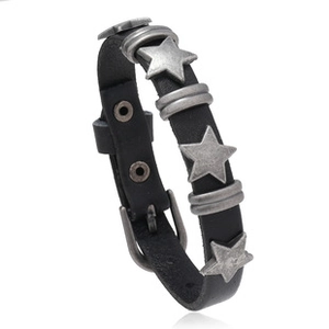 Detail view of black leather bracelet featuring vintage silver star studs and metal accents