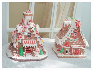 Detailed view of miniature Christmas gingerbread house with festive snow and snowman accents