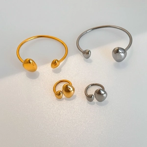 Detailed view of minimalist 18k gold plated stainless steel rings and bracelets