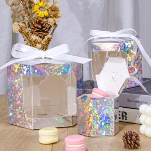 Macro view of hexagonal laser gift boxes with windows and white ribbons in various sizes