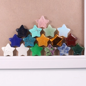 Macro view of 17 colorful star-shaped semi-precious stone pendants on cork surface