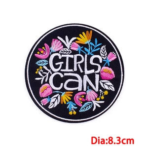 Embroidered flower patch with 'GIRLS CAN' text on black twill, 8.3cm round DIY accessory