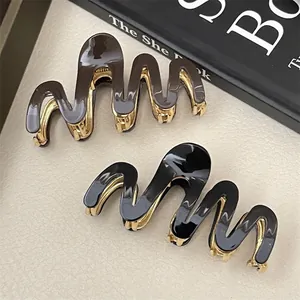 Elegant wavy tortoiseshell and black acetate hair claws with gold metal base